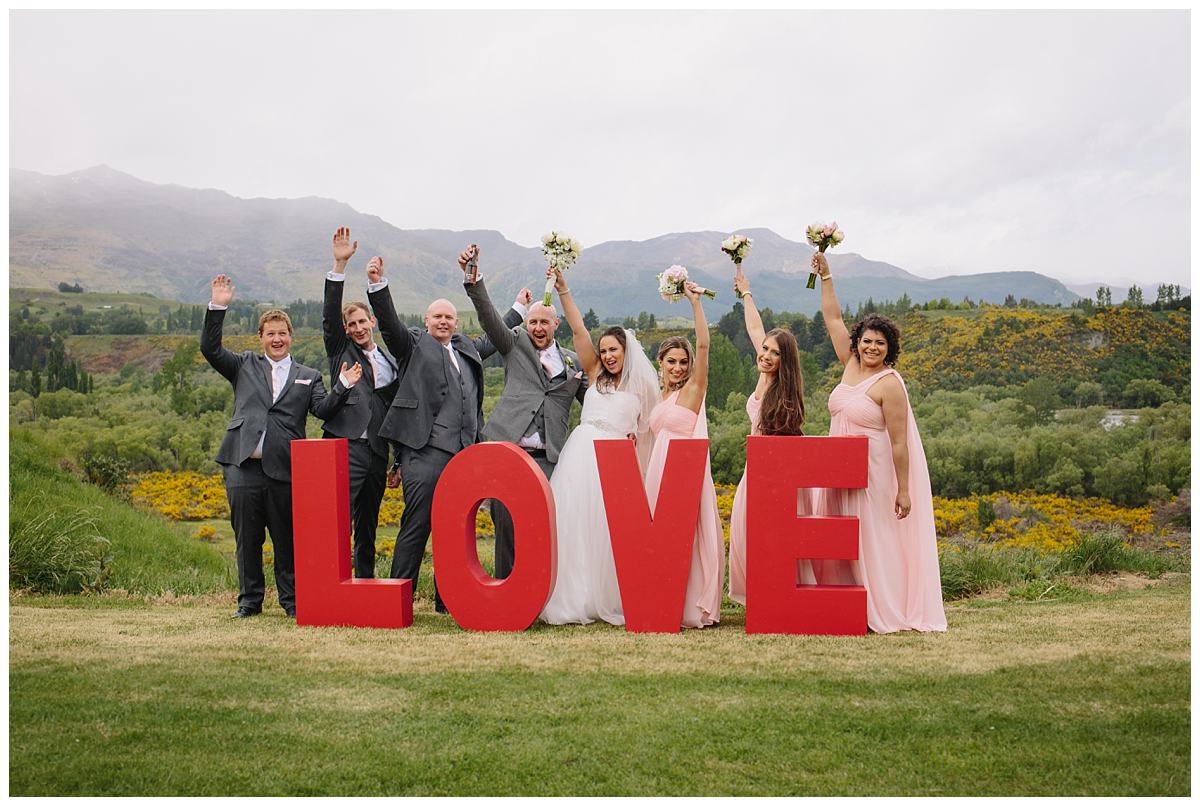 Bride and groom with bridesmaids and groomsmen at Tucker Beach in Queenstown