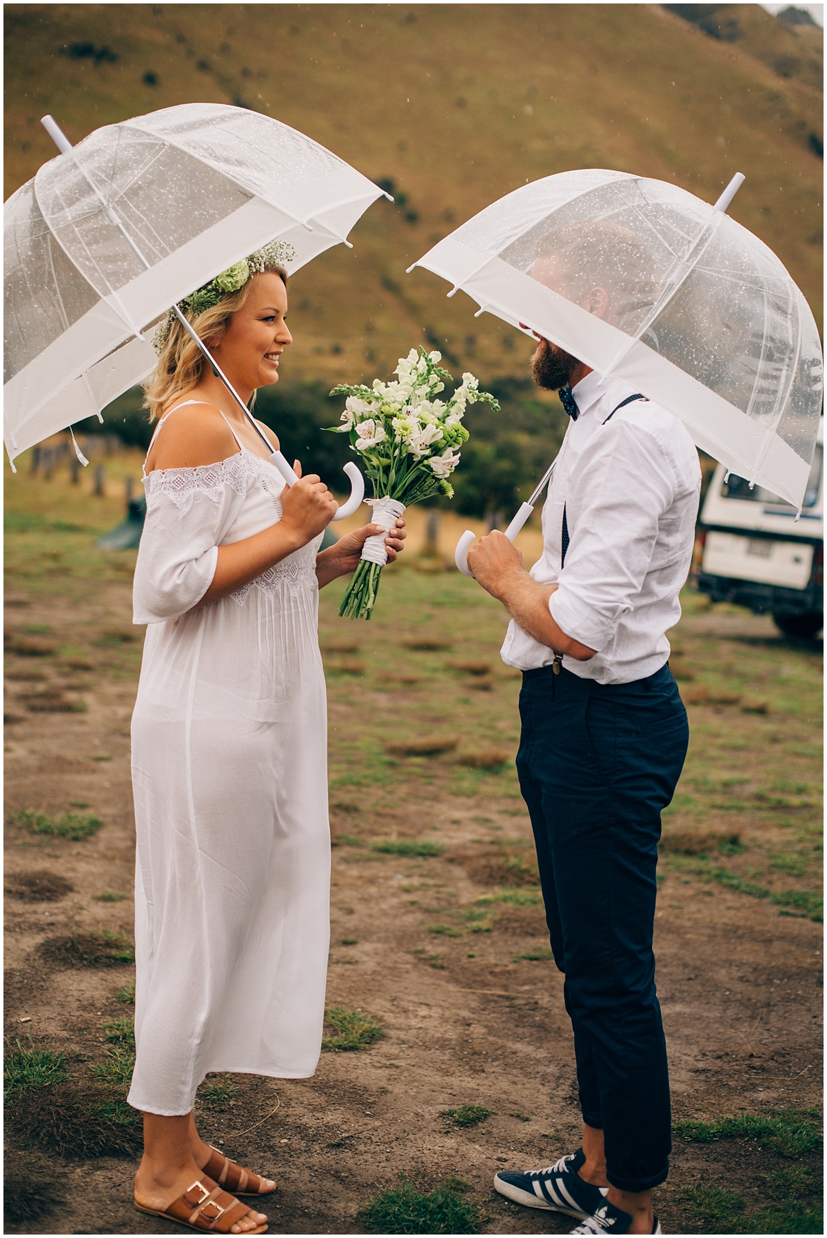 Bride and groom underneath umbrellas at Queenstown elopement