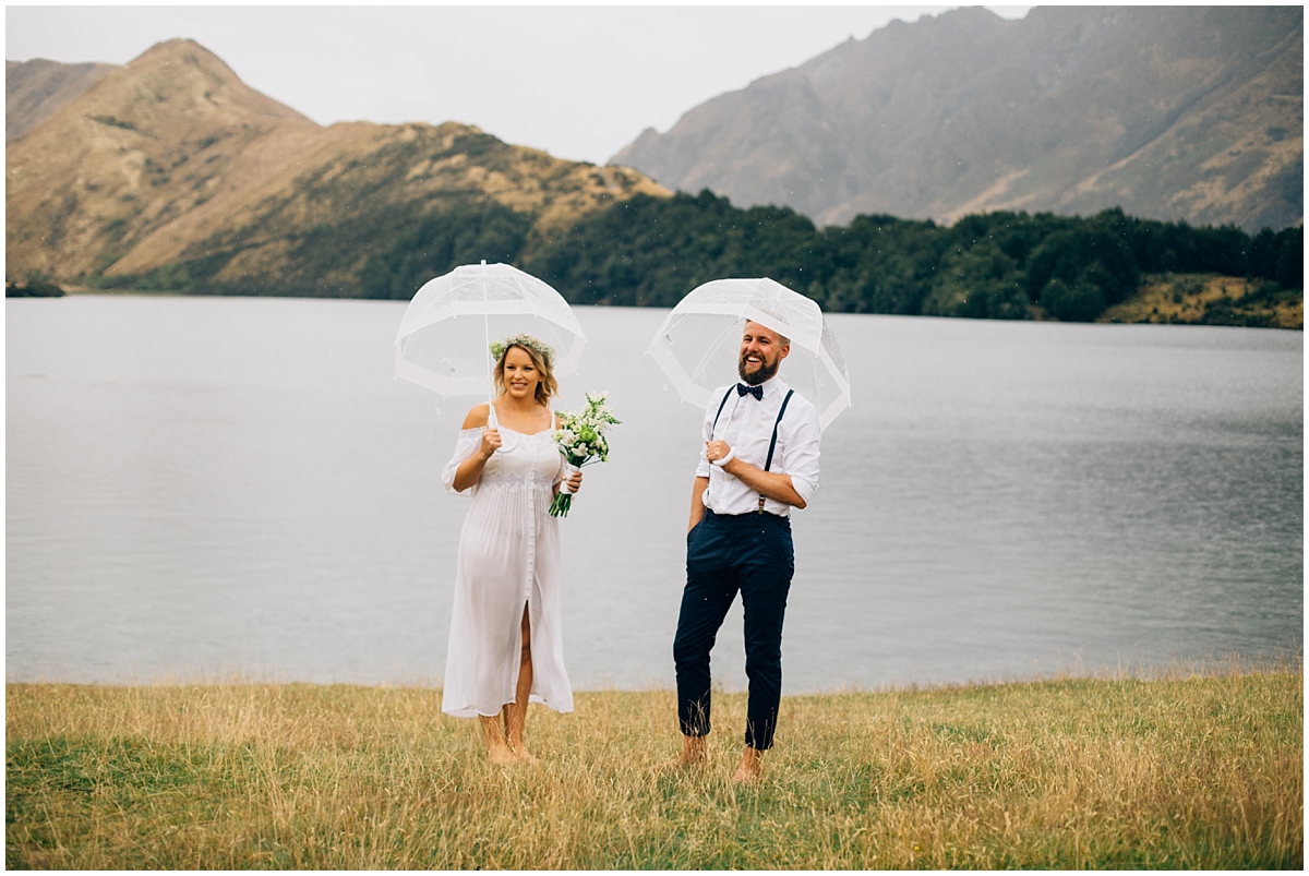 Bride and groom laugh on the shore of Moke Lake