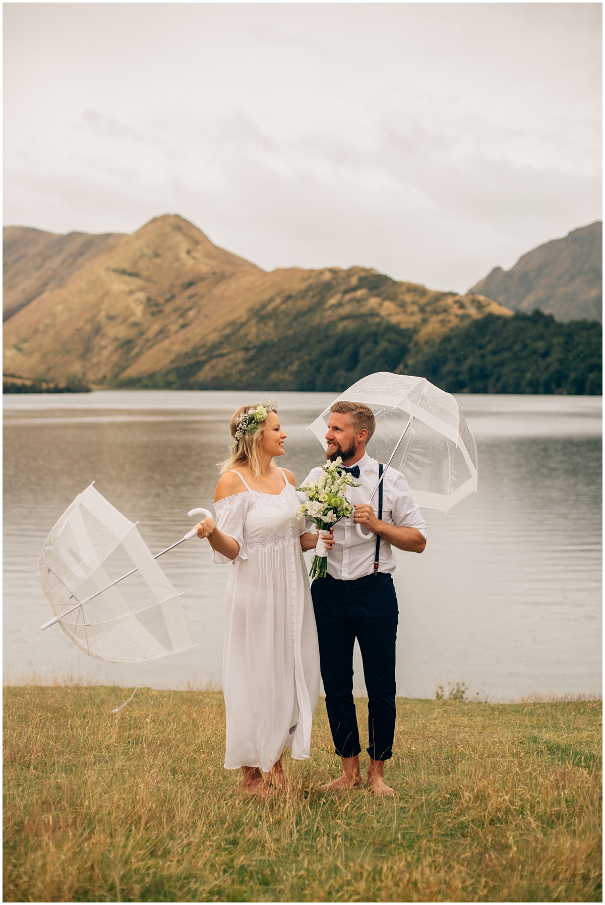 Bride and groom stand at the shore of Moke Lake